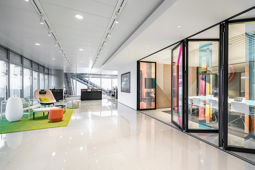 A room with glass walls and a table and chairs.